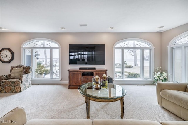 carpeted living area with visible vents and baseboards