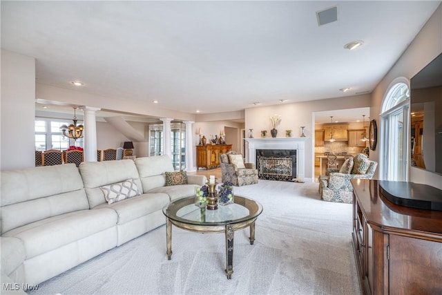 living area featuring visible vents, recessed lighting, carpet floors, a fireplace, and ornate columns