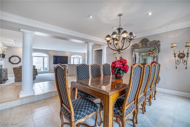 dining room with crown molding, baseboards, decorative columns, light tile patterned floors, and a notable chandelier