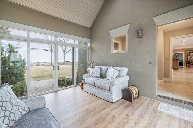 sunroom featuring vaulted ceiling