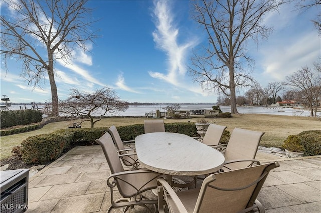 view of patio / terrace with outdoor dining area and a water view