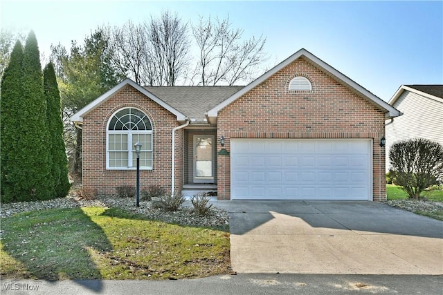 single story home featuring brick siding, an attached garage, driveway, and a shingled roof