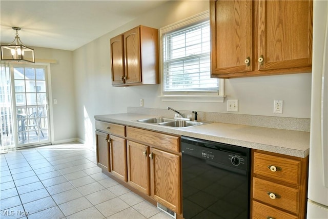 kitchen featuring a sink, dishwasher, light tile patterned floors, and light countertops