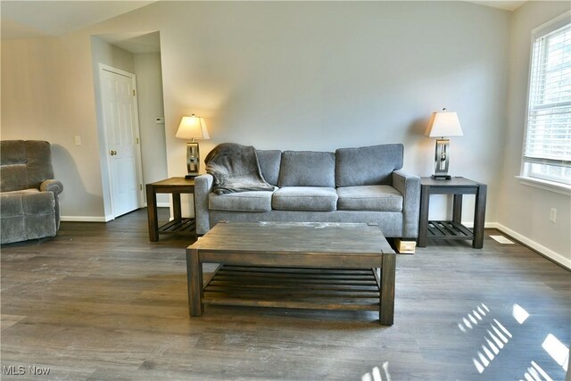 living area featuring wood finished floors and baseboards