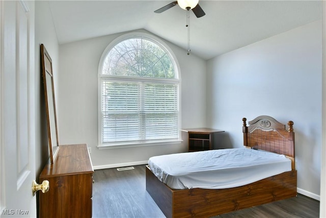 bedroom featuring vaulted ceiling, wood finished floors, visible vents, and baseboards