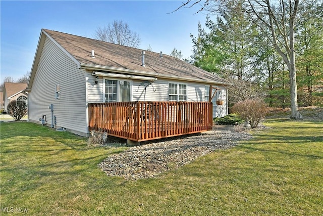 back of property featuring a lawn and a deck