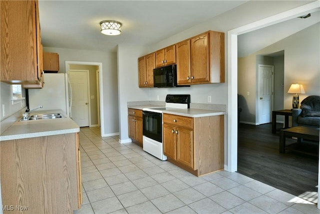 kitchen with light countertops, light tile patterned floors, black microwave, and electric range oven