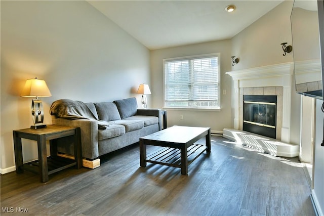 living area featuring a fireplace, baseboards, lofted ceiling, and dark wood-style flooring