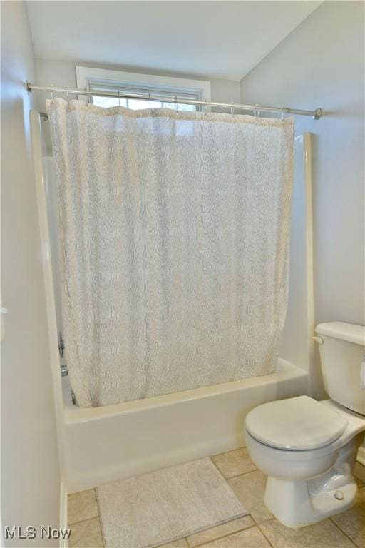 full bathroom with shower / tub combo with curtain, toilet, and tile patterned flooring