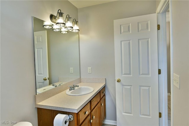 half bathroom featuring toilet and vanity