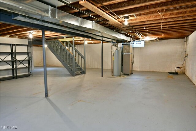 below grade area featuring stairs, gas water heater, and heating unit