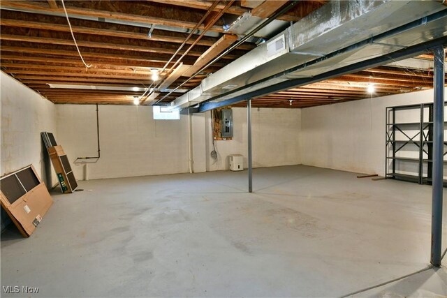 basement featuring electric panel and visible vents