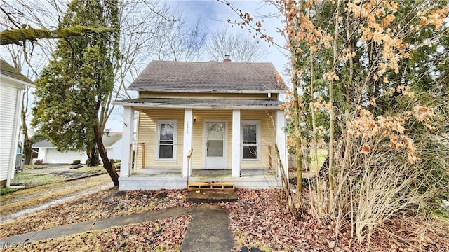 view of front of house with covered porch and roof with shingles