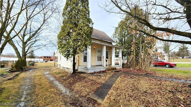 view of front facade with a porch and a shingled roof