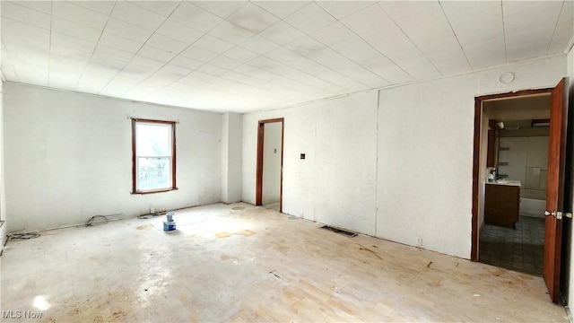 spare room featuring visible vents and unfinished concrete flooring