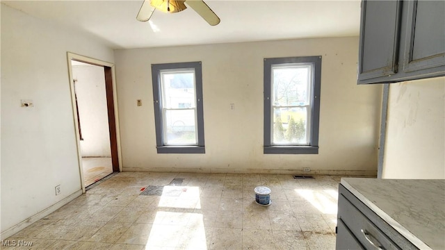 unfurnished dining area with plenty of natural light, visible vents, and ceiling fan