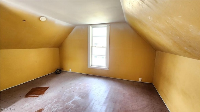 bonus room featuring lofted ceiling and tile patterned floors