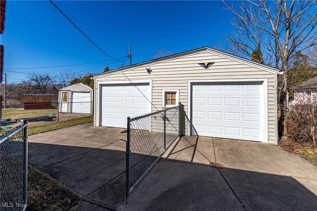 detached garage featuring fence