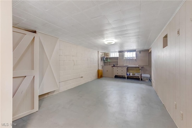 basement featuring tile patterned floors and concrete block wall