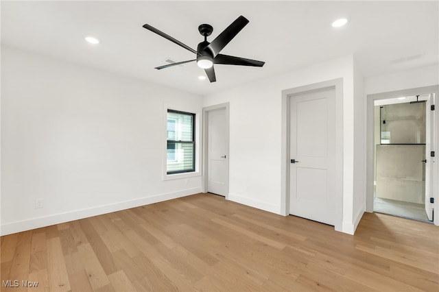 unfurnished bedroom featuring light wood-style flooring, recessed lighting, baseboards, and ensuite bathroom