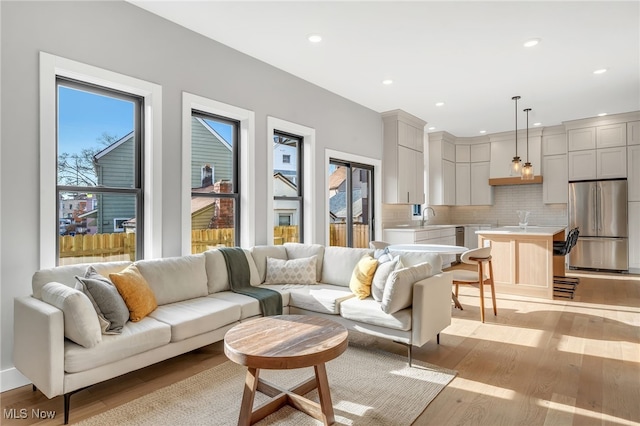 living area featuring recessed lighting and light wood-type flooring