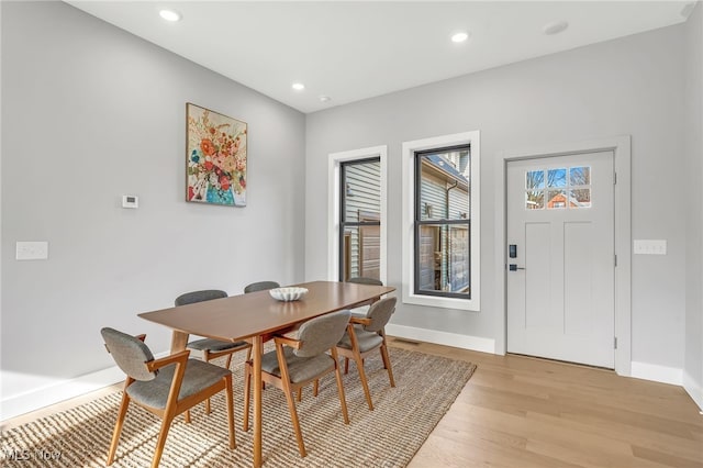 dining room with recessed lighting, light wood-type flooring, and baseboards