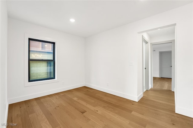 empty room with recessed lighting, baseboards, and light wood-style floors