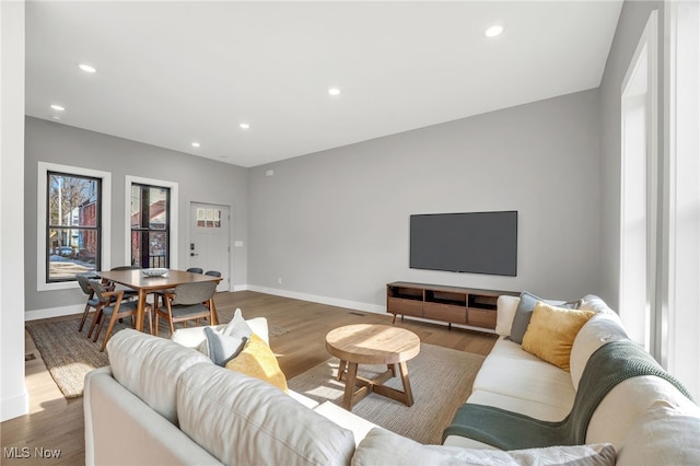 living room with recessed lighting, wood finished floors, and baseboards