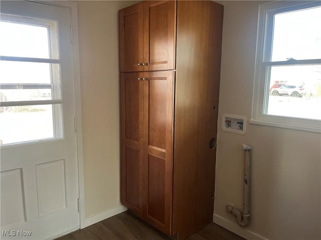 doorway to outside with dark wood-style floors, plenty of natural light, and baseboards