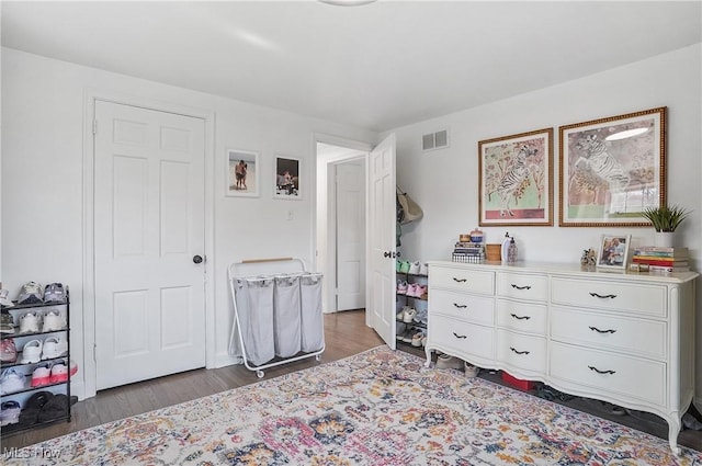 bedroom with wood finished floors and visible vents