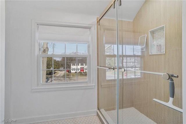 full bathroom featuring baseboards and a stall shower