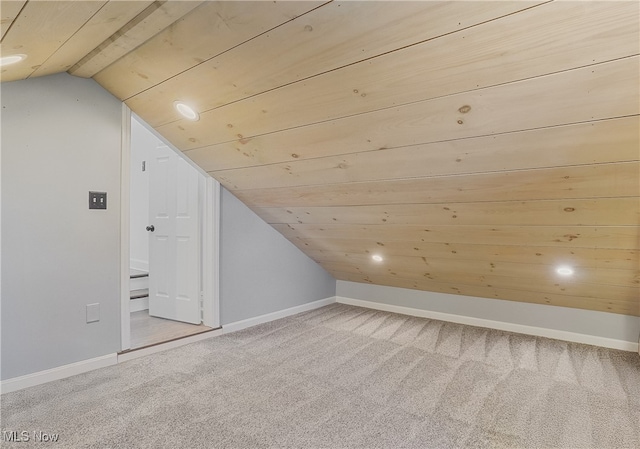 bonus room with vaulted ceiling, baseboards, and carpet floors