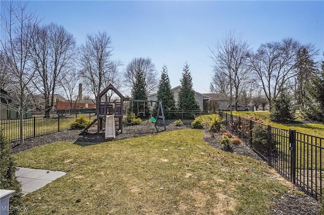 view of yard featuring playground community and a fenced backyard