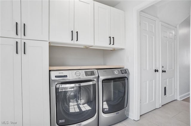 washroom featuring cabinet space and washer and dryer