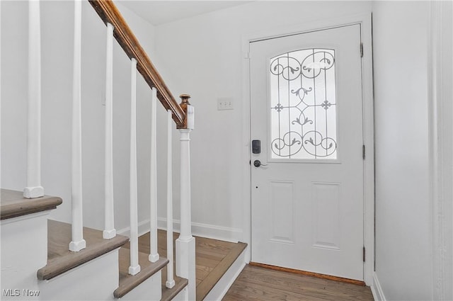 foyer entrance with stairway and wood finished floors