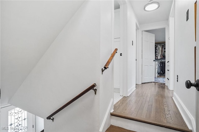 stairs featuring baseboards and wood finished floors