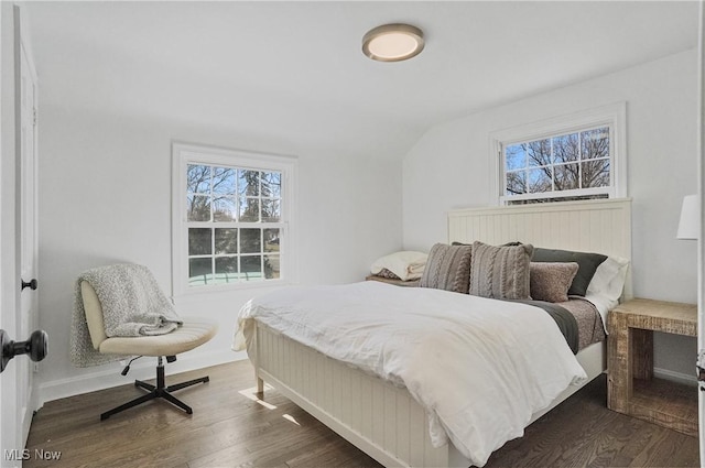 bedroom with dark wood finished floors and vaulted ceiling