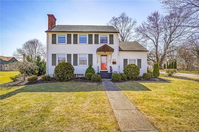 view of front of property featuring a front yard and a chimney