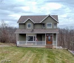 view of front of property featuring a front yard and covered porch