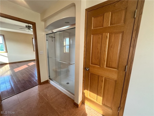 17583 Davis Ridge Rd, Caldwell, OH 43724 - full bathroom featuring baseboards, a shower stall, ceiling fan, and tile patterned floors