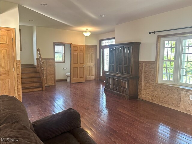 17583 Davis Ridge Rd, Caldwell, OH 43724 - living room with dark wood-type flooring, plenty of natural light, stairs, and a wainscoted wall