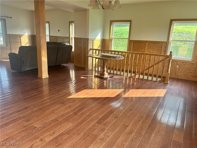 17583 Davis Ridge Rd, Caldwell, OH 43724 - unfurnished room featuring a wainscoted wall, wood finished floors, healthy amount of natural light, and a chandelier