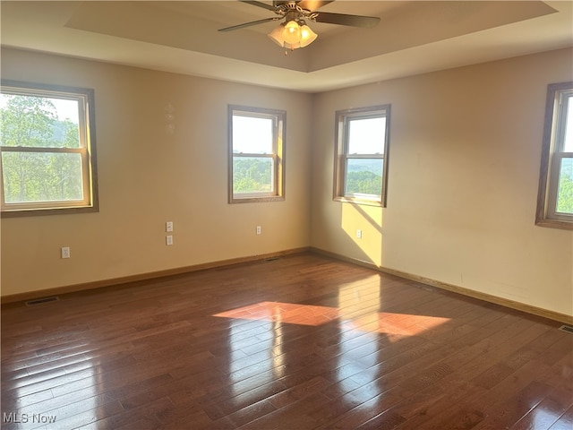 17583 Davis Ridge Rd, Caldwell, OH 43724 - unfurnished room with a raised ceiling, hardwood / wood-style floors, baseboards, and ceiling fan