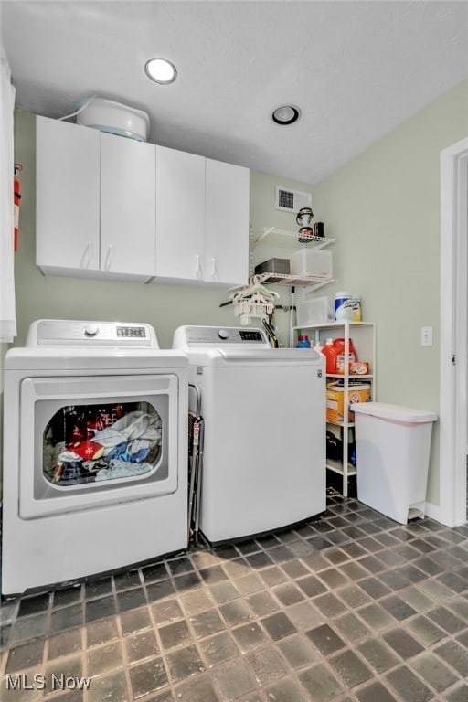 washroom with recessed lighting, visible vents, cabinet space, and separate washer and dryer