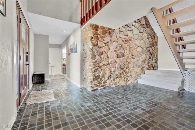 interior space with stairs and baseboards