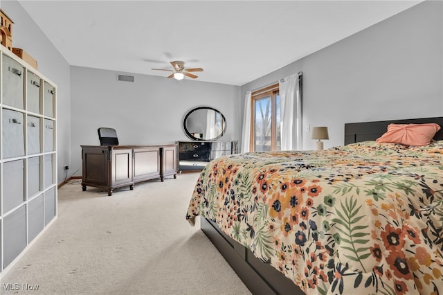 bedroom featuring visible vents, light carpet, and a ceiling fan