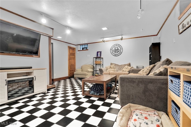 living room featuring tile patterned floors, rail lighting, a textured ceiling, and crown molding