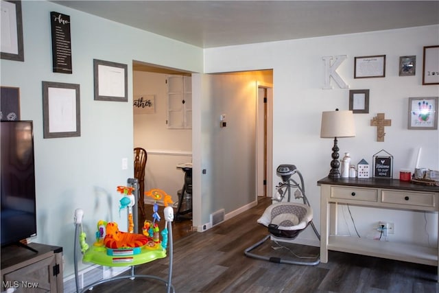 interior space featuring dark wood-style floors, visible vents, and baseboards