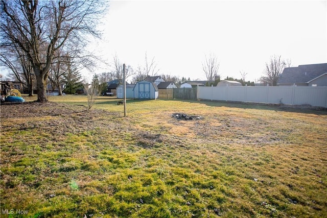 view of yard with a storage unit, an outdoor structure, and fence