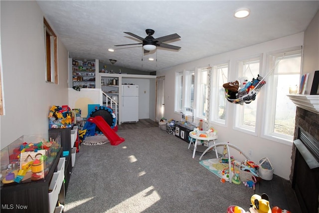 recreation room featuring recessed lighting, a ceiling fan, carpet, and a fireplace